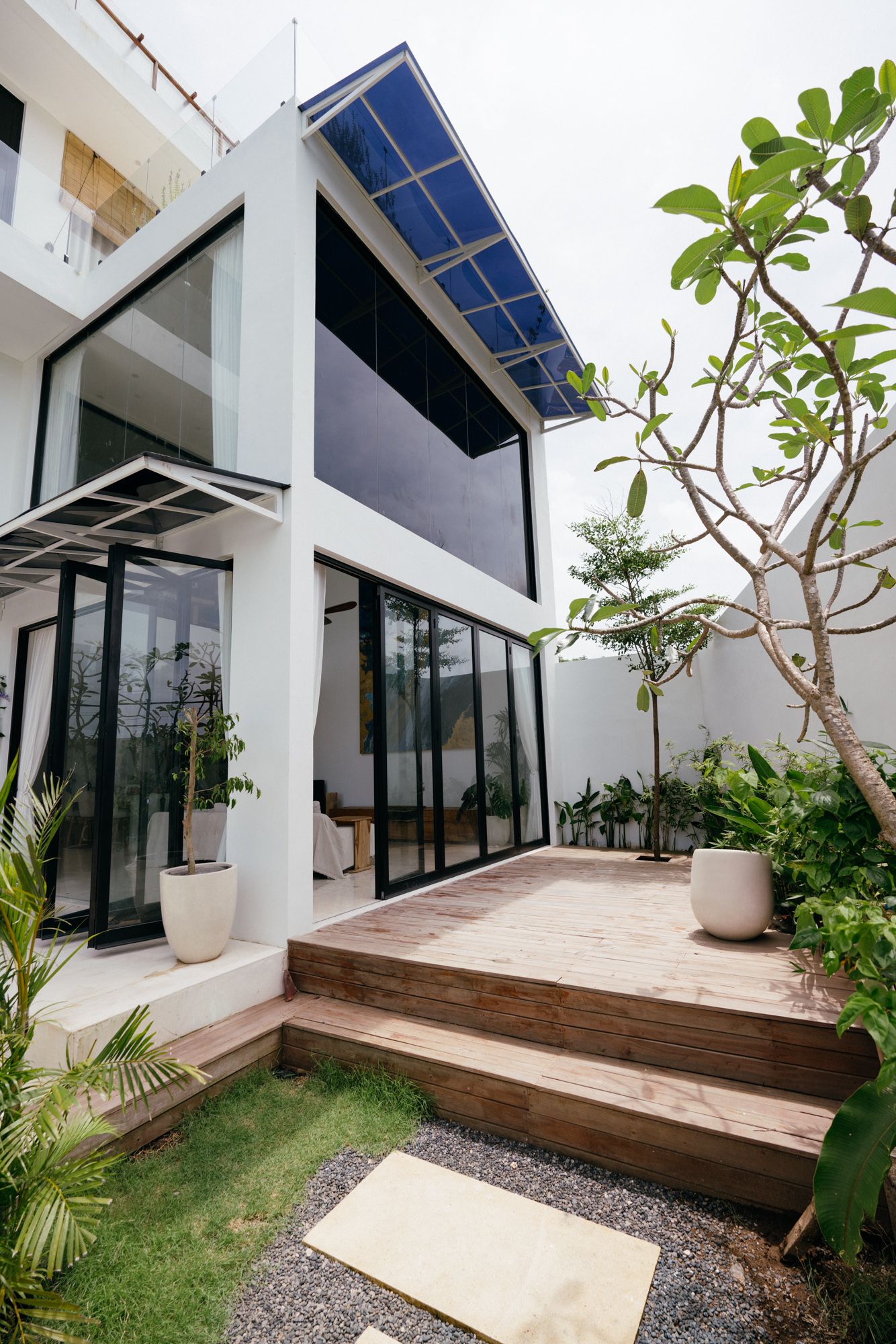 Marble steps rising through the garden between the white walls.